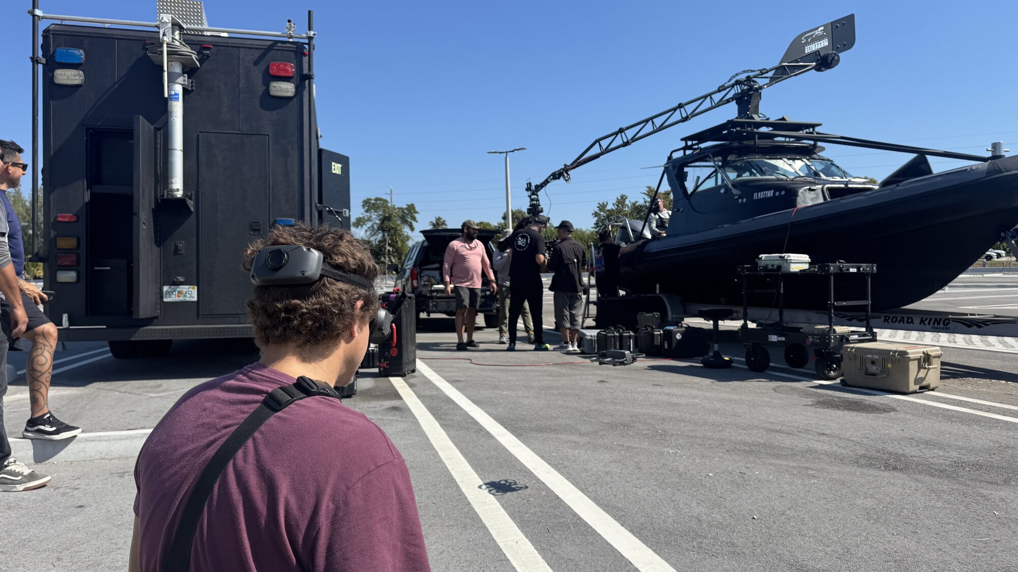 Operators carrying a Movi Pro stabilizer rig at the staging lot