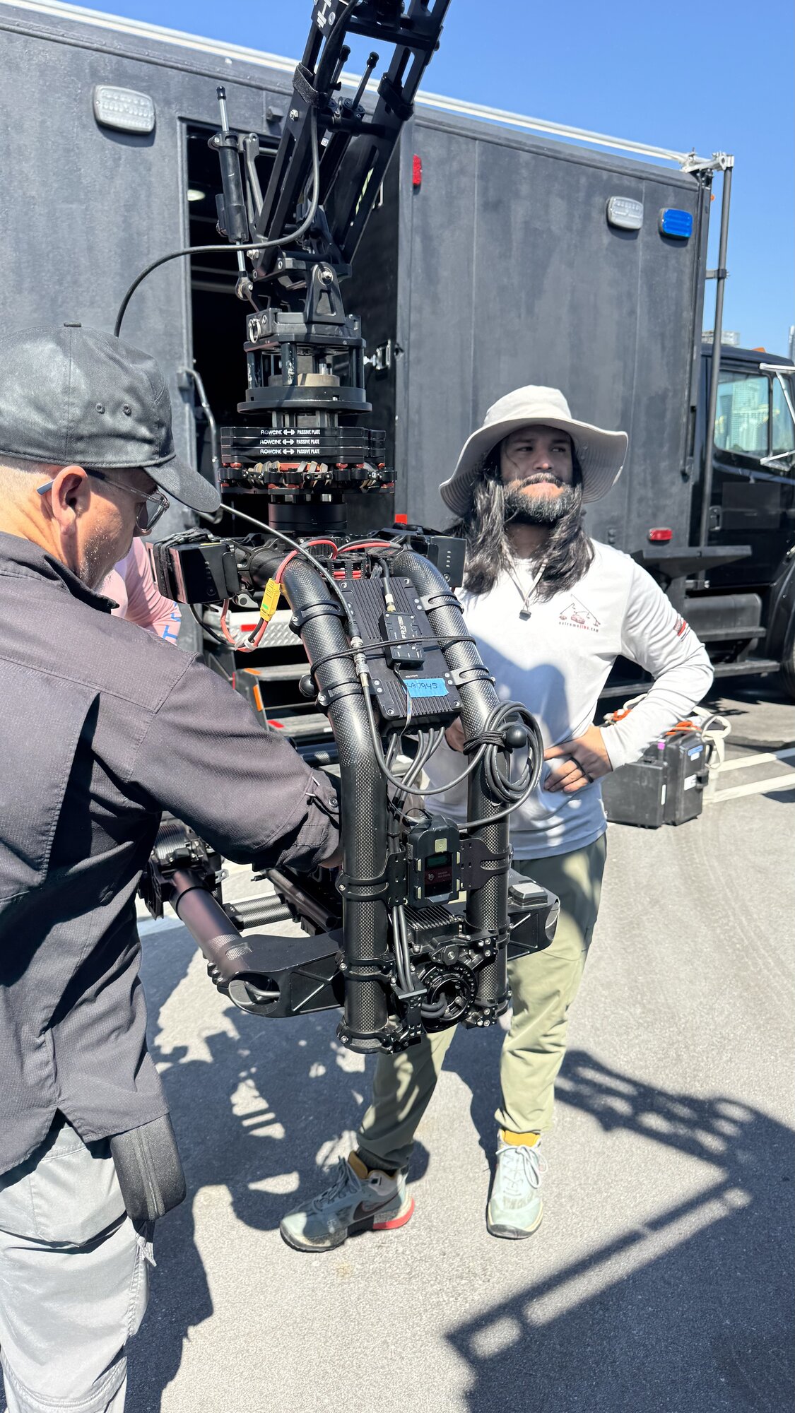 FPV drone pilot with goggles working alongside the rig